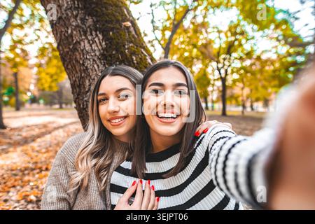 Two Women Taking a Selfie in a Park Stock Photo