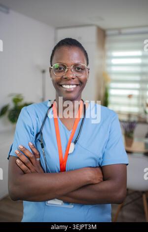 Confident African American female doctor smiling with arms crossed Stock Photo
