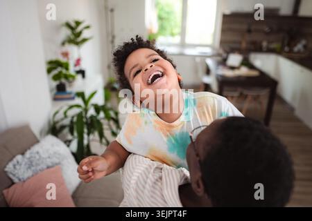 Black father and son laughing having fun at home Stock Photo
