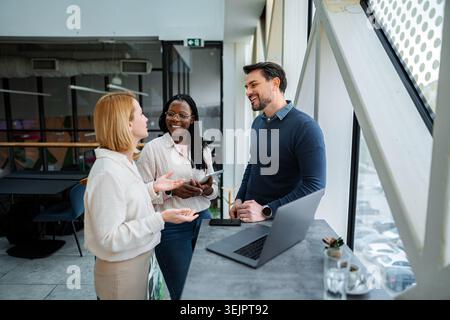 Diverse business professionals having informal meeting in modern office Stock Photo