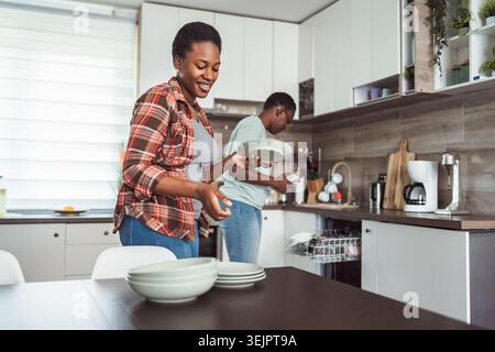 Couple Doing Dishes Together in Modern Kitchen Stock Photo