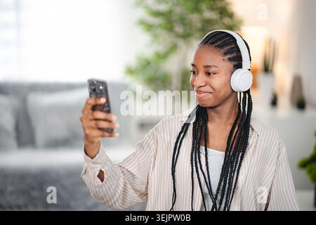 Young Black woman having video call using smartphone Stock Photo