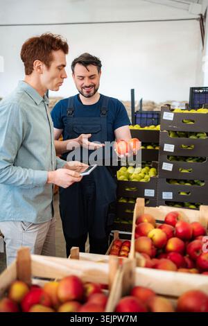 Farm worker and inspector checking organic produce quality Stock Photo