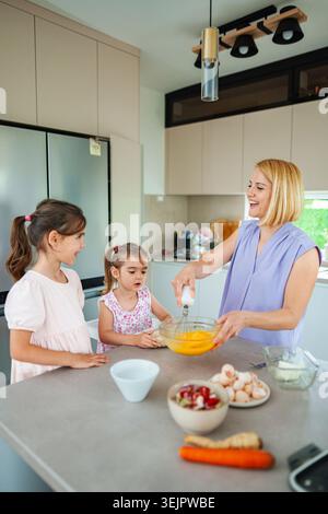 Enjoying family time while baking in the bright kitchen Stock Photo