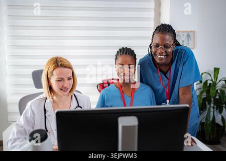 Diverse medical team collaborating on digital healthcare solutions Stock Photo