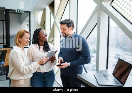 Diverse startup team collaborating using digital tablet and technology Stock Photo