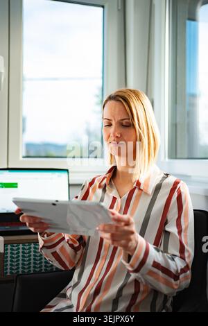 Woman closing eyes feeling tired from digital tablet work Stock Photo