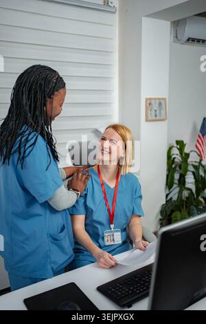 Diverse healthcare professionals working together in hospital administration office Stock Photo