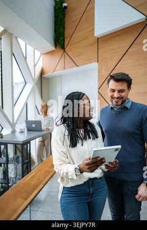 Diverse business team collaborating in modern office discussing new strategies Stock Photo