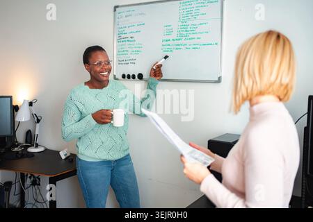 Diverse businesswomen discussing strategy during office meeting Stock Photo