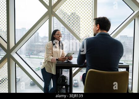 Business colleagues collaborating using digital tablet in modern office Stock Photo
