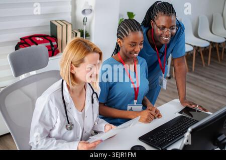 Healthcare professionals analyzing patient data and records together Stock Photo