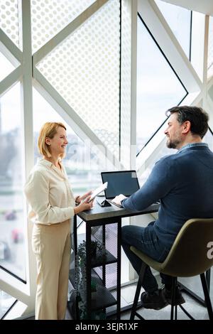 Successful business colleagues collaborating on project in modern office Stock Photo