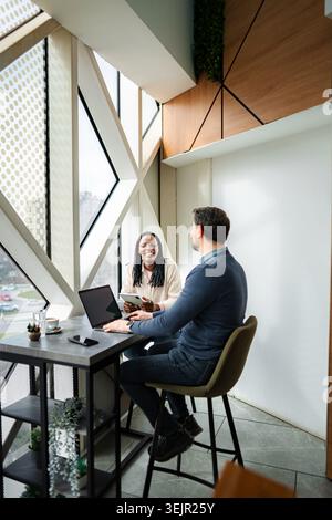 Diverse business professionals collaborating in a modern coworking space Stock Photo