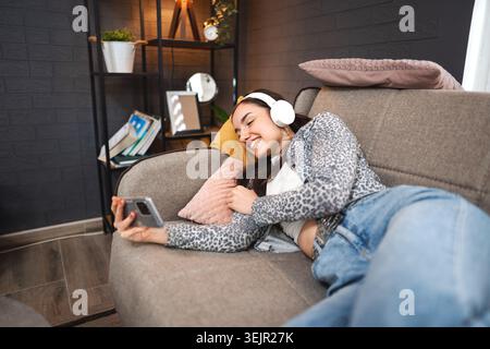 Relaxed young woman using mobile phone Stock Photo
