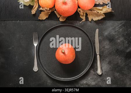 Thanksgiving Day or Halloween place setting with pumpkin. Top view. Stock Photo