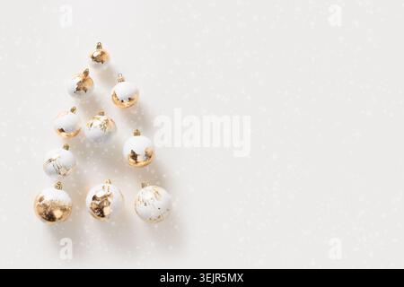 Banner with Christmas Tree made of golden balls on white. Stock Photo