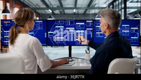 Two Software Developers Collaborate On Low Code Platform Using Drag And Drop Tools. Stock Photo