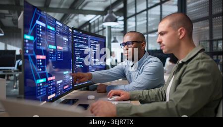 Two Young Black Men Collaborate On Visual Workflow Editor Using Software. Stock Photo