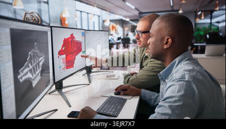 Two Mechanical Engineers Are Working Together On 3D CAD Designs At Office. Stock Photo