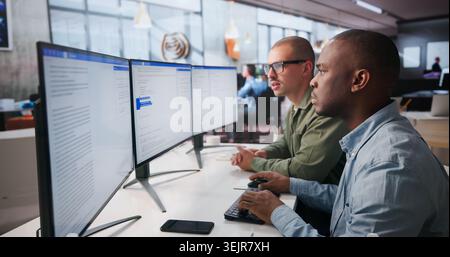 Two Software Engineers Work Together On Secure Web Application Coding. Stock Photo