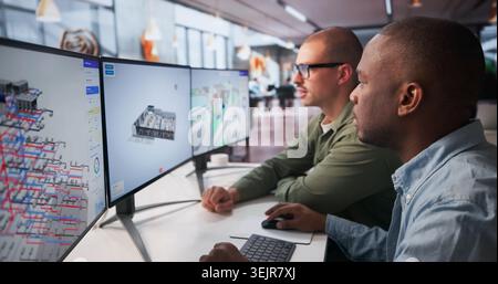 Two Engineers Working Together On 3D BIM Software For Building Design. Stock Photo