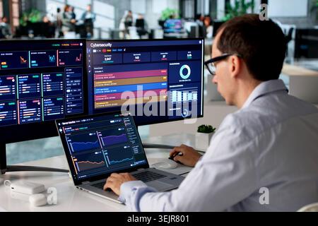 IT Specialist Uses Laptop To Monitor Real-time Network Security Alerts. Stock Photo