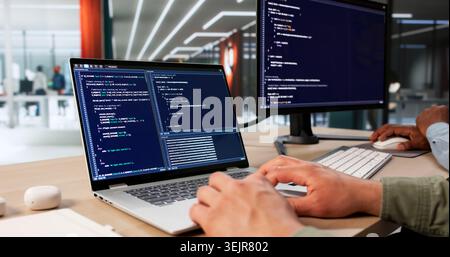 Two Software Engineers Work Together Coding Secure Data Systems At Desk. Stock Photo