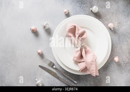 Christmas festive table setting with pink towel on gray table. Stock Photo