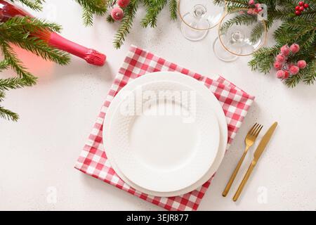 Christmas table setting with elegant red decorations on white table. Stock Photo