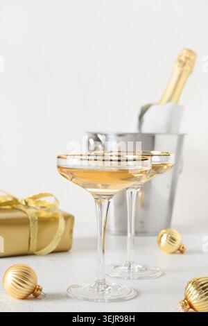 Festive New Year champagne and Christmas silver baubles on white background. Stock Photo