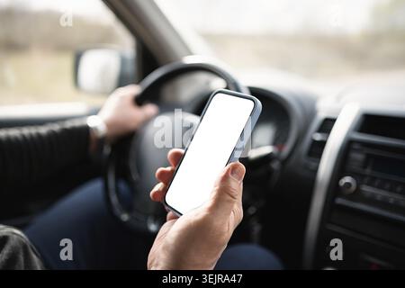 Driver Using Smartphone With Blank Screen Inside Car Stock Photo