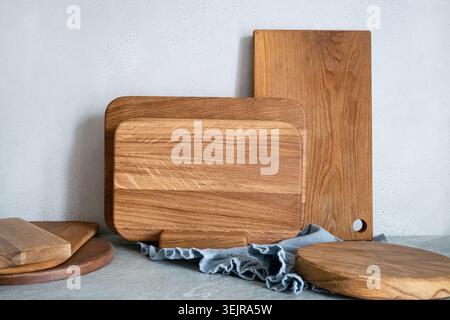Wooden cutting boards set on kitchen table rustic cooking background Stock Photo