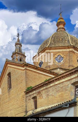 Dome of Santa Maria Church in Ecija, Spain, close up view. Traditional baroque architecture, ceramic tiles, cloudy sky Stock Photo