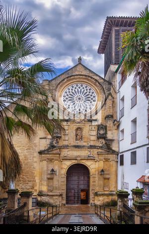 Facade of San Pablo church in Cordoba, Spain, front view. Stone religious architecture under cloudy sky in soft light Stock Photo