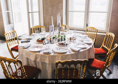 Round banquet table set for wedding reception in elegant dining room Stock Photo