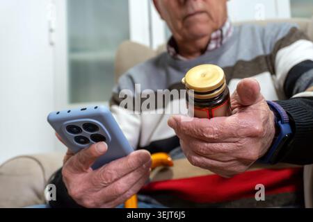 Senior man using smartphone for medication management Stock Photo