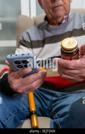 Senior man using smartphone researching medicine information Stock Photo