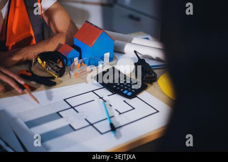 Two technicians inspect server racks in data center with tablet and fiber optic cable. Engineer and specialist discuss maintenance work in data center Stock Photo