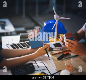 Two technicians inspect server racks in data center with tablet and fiber optic cable. Engineer and specialist discuss maintenance work in data center Stock Photo