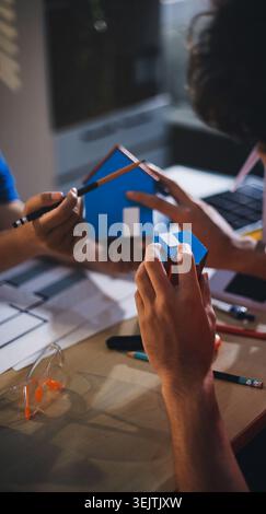 Two technicians inspect server racks in data center with tablet and fiber optic cable. Engineer and specialist discuss maintenance work in data center Stock Photo