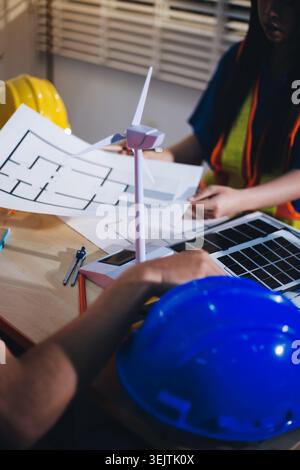 Two technicians inspect server racks in data center with tablet and fiber optic cable. Engineer and specialist discuss maintenance work in data center Stock Photo