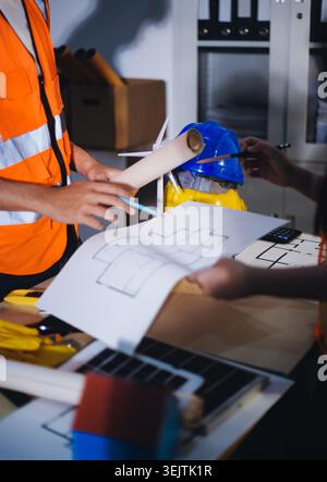 Two technicians inspect server racks in data center with tablet and fiber optic cable. Engineer and specialist discuss maintenance work in data center Stock Photo