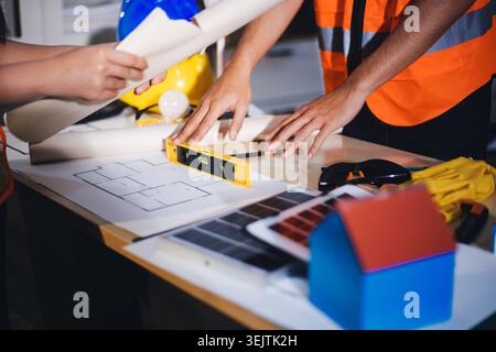 Two technicians inspect server racks in data center with tablet and fiber optic cable. Engineer and specialist discuss maintenance work in data center Stock Photo