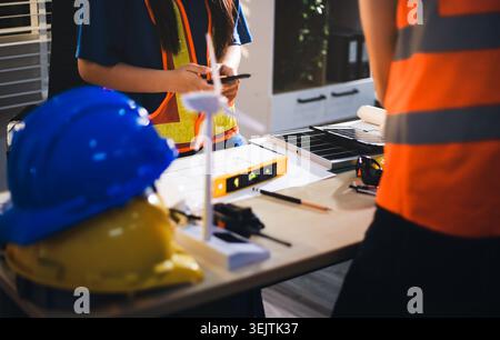 Two technicians inspect server racks in data center with tablet and fiber optic cable. Engineer and specialist discuss maintenance work in data center Stock Photo