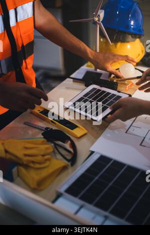 Two technicians inspect server racks in data center with tablet and fiber optic cable. Engineer and specialist discuss maintenance work in data center Stock Photo
