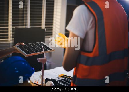 Two technicians inspect server racks in data center with tablet and fiber optic cable. Engineer and specialist discuss maintenance work in data center Stock Photo