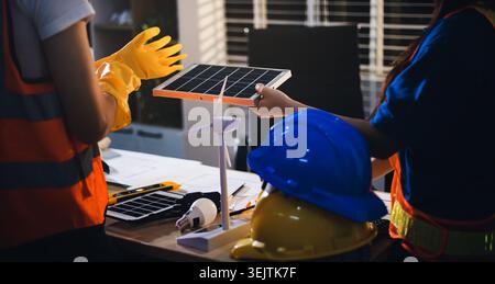 Two technicians inspect server racks in data center with tablet and fiber optic cable. Engineer and specialist discuss maintenance work in data center Stock Photo