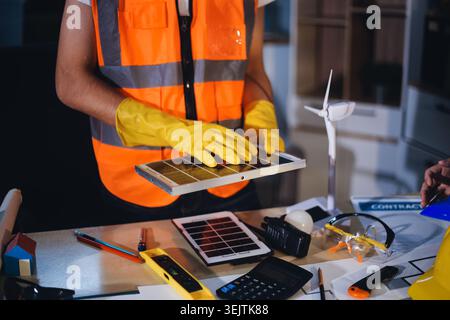 Two technicians inspect server racks in data center with tablet and fiber optic cable. Engineer and specialist discuss maintenance work in data center Stock Photo