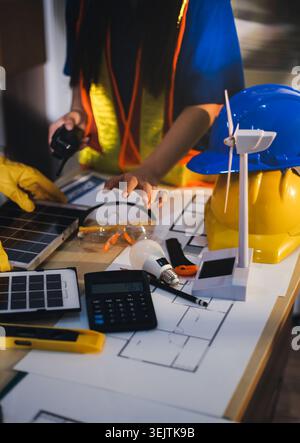 Two technicians inspect server racks in data center with tablet and fiber optic cable. Engineer and specialist discuss maintenance work in data center Stock Photo